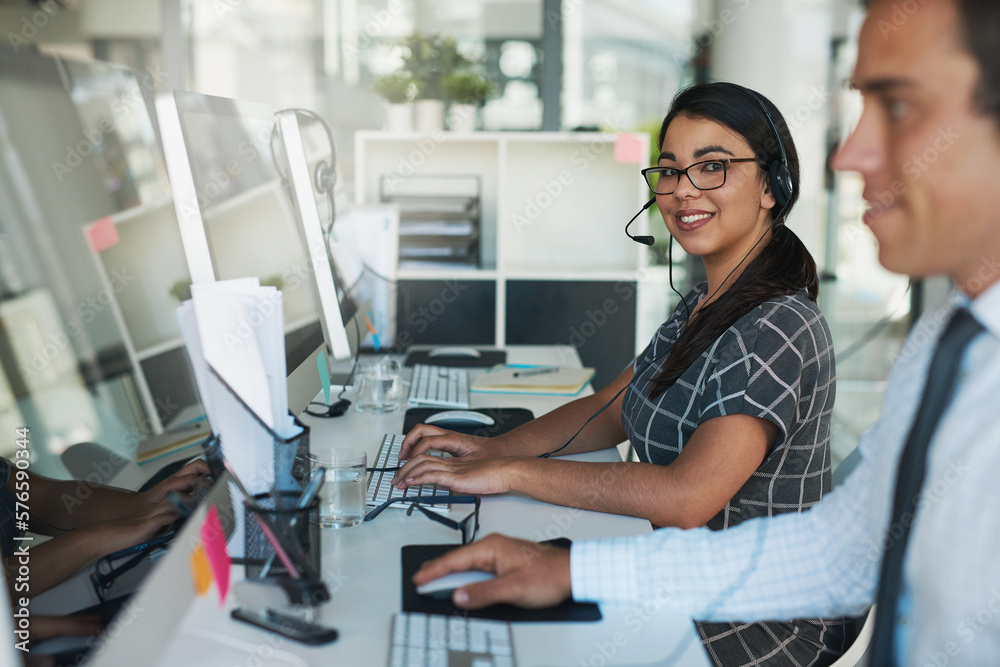Poster ready and available to take your call. portrait of a happy and confident young woman working in a ca