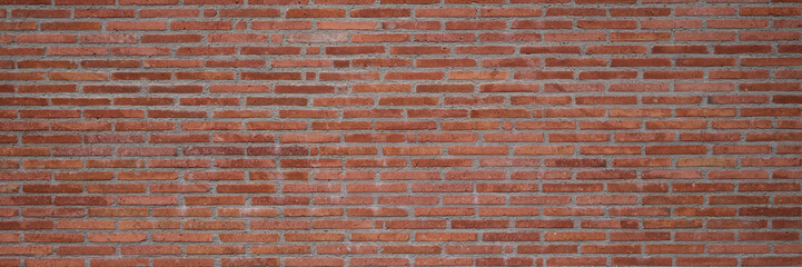 Texture of the wall of thin long red bricks