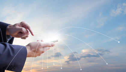 Mobile phone with white screen in hands on the backgound of blue sky, business communication