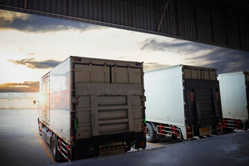 Trucks Parked Loading at Dock Warehouse. Lift Ramp Hydraulic. Shipping Cargo Container Delivery Trucks. Loading Distribution Warehouse. Freight Trucks Cargo Transport Logistics