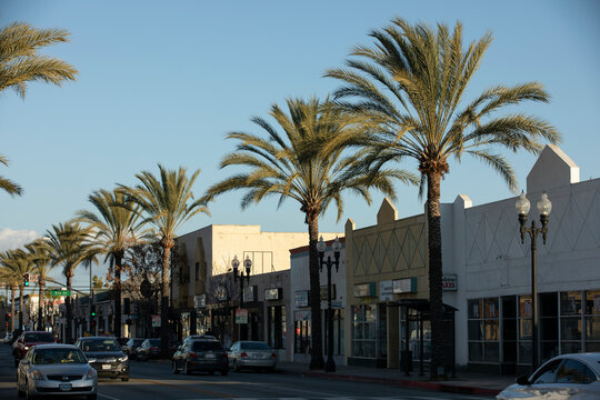 Montebello, California, USA - February 2, 2023: Afternoon sunlight shines on historic street lamps and facades of downtown Montebello.