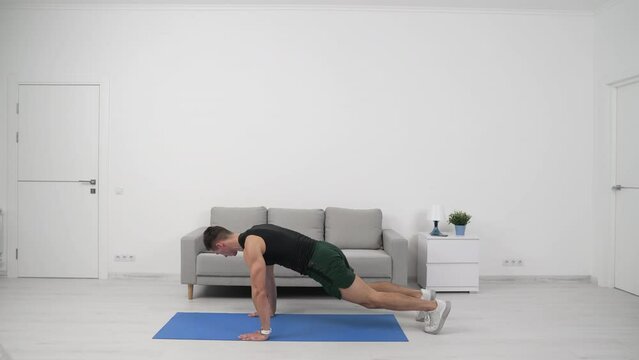 Fitness man athlete exercising plank knee to elbow workout. Sport man athlete bending knees