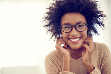 Some of the happiest times are spent at home. Portrait of a happy young woman relaxing at home.