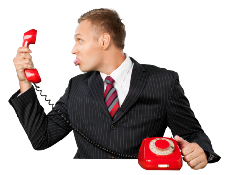 Close-up of business man in suit holding red phone isolated on white background