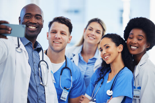 Healthcare, selfie and team of doctors at hospital, happy and proud, smile and bond on blurred background. Medical, diversity and group pose for photo, profile picture or website homepage update