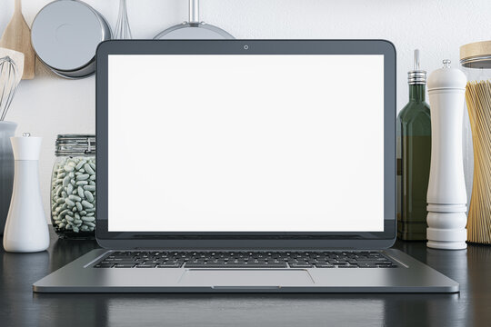 Online cooking master class concept with blank white modern laptop monitor with space for your logo or web page advertising among kitchenware on light wall background. 3D rendering, mockup