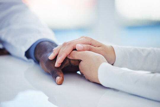 Hands, healthcare or comfort with a doctor and patient in a hospital during an appointment or checkup. Medical, support and trust with a medicine professional showing empathy while consulting