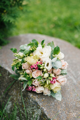 Obraz na płótnie Canvas Wedding beautiful rustic bouquet of flowers on the old stone
