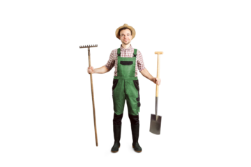 Smiling gardener holding a rake and a spade