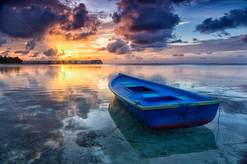 Panorama of tropical island resort with over-water bungalows at night. Maldives. Kaafu Atoll and South Male Atoll. Scenic sunset over the Ocean. guraidhoo