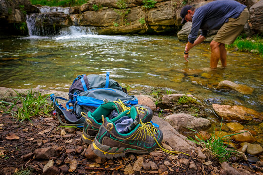 Hiker standing in stream during daytime, Christopher Creek, Arizona, USA