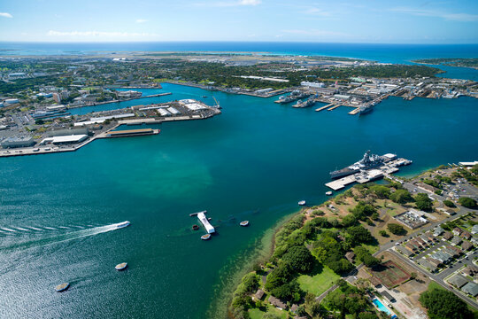 Helicopter overview of Pearl Harbor with Arizona memorial and mighty Mo Missouri ship