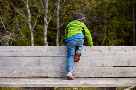 Little boy climbing on wooden bench in&Acirc;&nbsp;Bruce Peninsula National Park