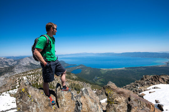 A man stands on the summit of Mount Tallac looking out over Lake Tahoe near South Lake Tahoe, California.
