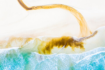 Brown stream entering Pacific Ocean, Queensland, Australia