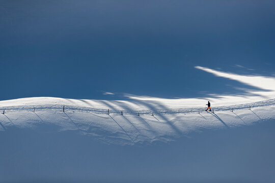 Person walking along path in snow, &Acirc;&nbsp;Gingins, &Acirc;&nbsp;Vaud&Acirc;&nbsp;Canton, Switzerland