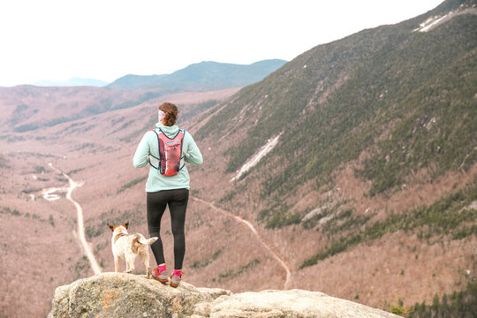Woman hiking with dog, Mt Willard, New Hampshire, USA