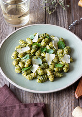 Gnocchi with pesto sauce, basil and Parmesan cheese. Healthy food. Vegetarian food. Diet.