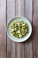 Gnocchi with pesto sauce, basil and Parmesan cheese. Healthy food. Vegetarian food. Diet.