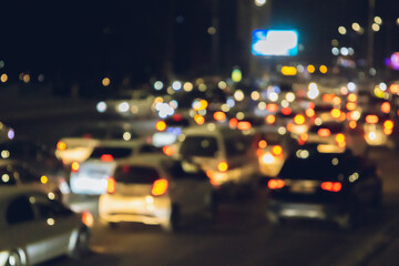 Abstract bokeh background and texture of a night street with cars and street lamps. City life,...