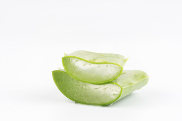 Fresh aloe vera leaves and slices isolate against white background for health and beauty products.