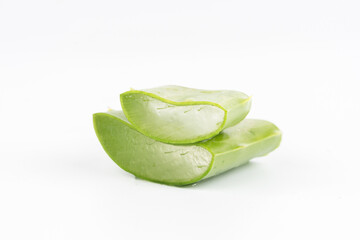 Fresh aloe vera leaves and slices isolate against white background for health and beauty products.