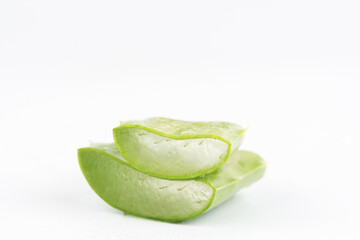 Fresh aloe vera leaves and slices isolate against white background for health and beauty products.