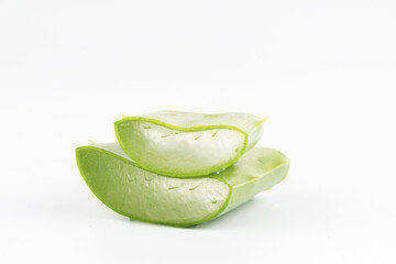 Fresh aloe vera leaves and slices isolate against white background for health and beauty products.
