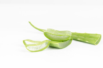 Fresh aloe vera leaves and slices isolate against white background for health and beauty products.