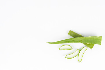 Fresh aloe vera leaves and slices isolate against white background for health and beauty products.