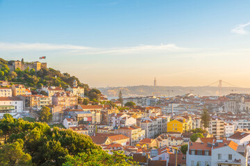 Sunset view of Lisbon old town on Tagus river with medieval buildings and castle. Lisboa, Portugal skyline