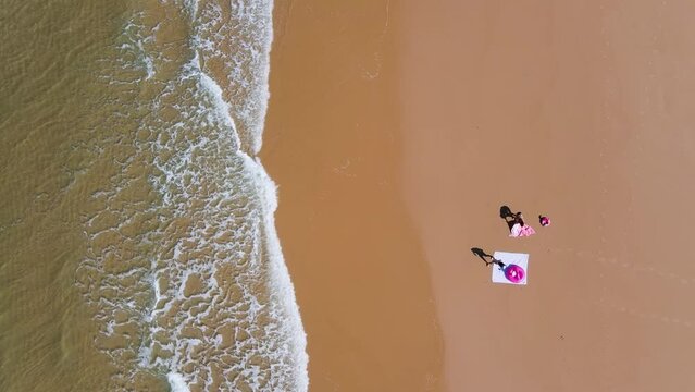 girls womans females spread their towels on the beach waves lacanau ocean nouvelle aquitaine France europe summertime vibes drone aerial above top view friends relaxing sea surf French spot salty 