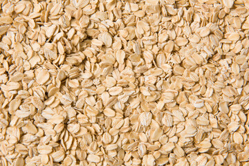 Rolled oat, oat flakes background or texture.