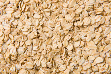 Rolled oat, oat flakes background or texture.