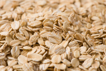 Rolled oat, oat flakes background or texture.