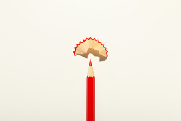 Red pencil on white background, close up