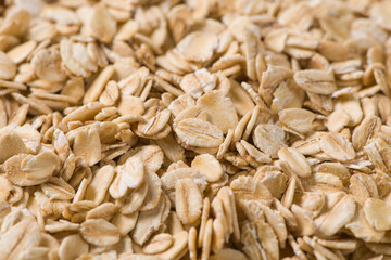 Rolled oat, oat flakes background or texture.