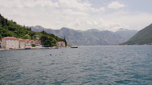 Peaceful lake surrounded by mountains - view from Perast, Montenegro