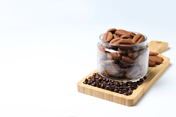 Concept of tasty snack for hot drink - cookies in the shape of coffee seeds