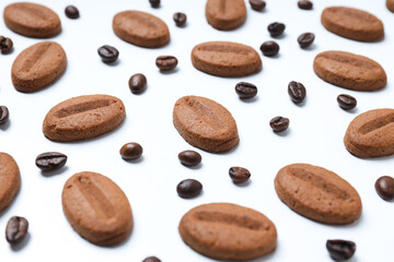 Concept of tasty snack for hot drink - cookies in the shape of coffee seeds