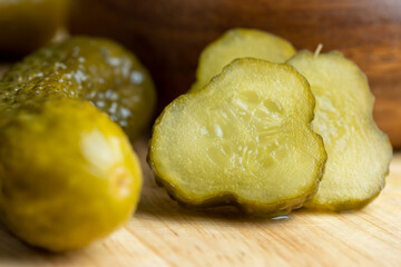 Pickled cucumbers on a wooden table during cooking