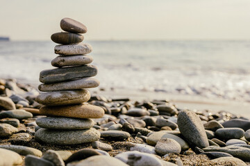 Fototapeta na wymiar Balanced cairn on the beach