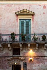 Fototapeta na wymiar Facade of the house with shutters and balcony in Matera. Basilicata, Italy