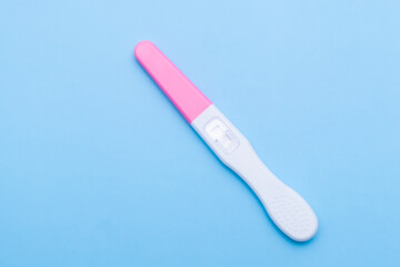 Close up unused pregnancy test on the blue background. Planning of pregnancy 