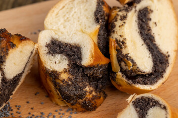 Fresh bun with poppy seed filling on the table
