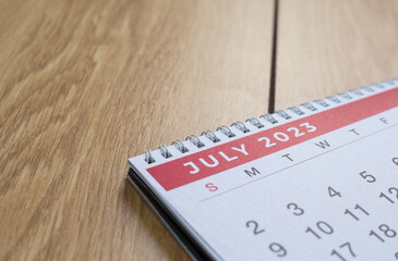 Closeup shot of a 2023 calendar, "July page". Selective focus shot of a calendar, focused on "July, 2023".