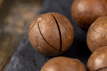 Unpeeled macadamia nuts on the table