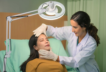Asian beautiful woman consulting about Cosmetic surgeon and make Botox injections on face for beauty procedures.  Plastic surgery in face of woman
