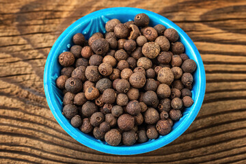 Allspice spice in a small bowl on the table
