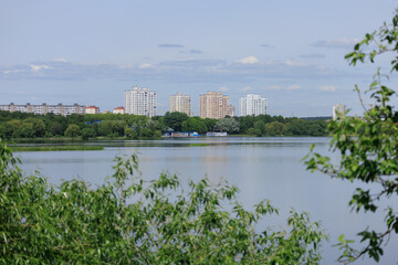 Fototapeta premium Buildings and houses standing on the shore of a lake, river or sea. 